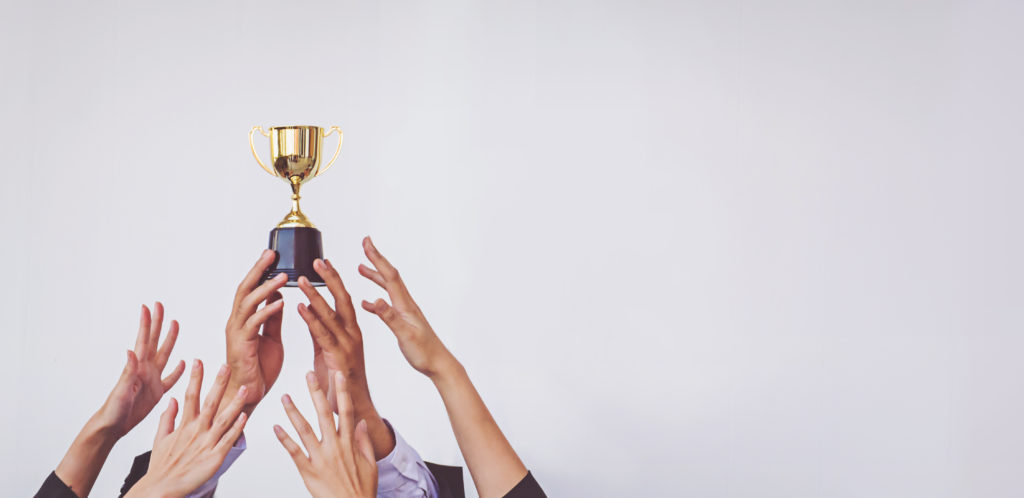 Hands scramble for the golden trophy cup, concept business bancos con los mejores prestamos