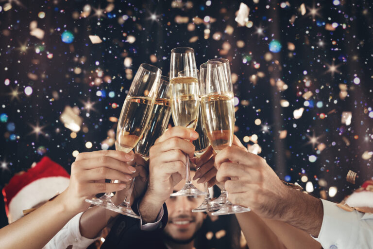 Clinking glasses of champagne in hands at New Year party Clinking glasses of champagne in hands at New Year party