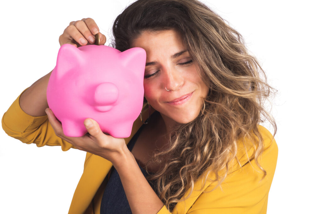 Woman holding a piggy bank on studio.